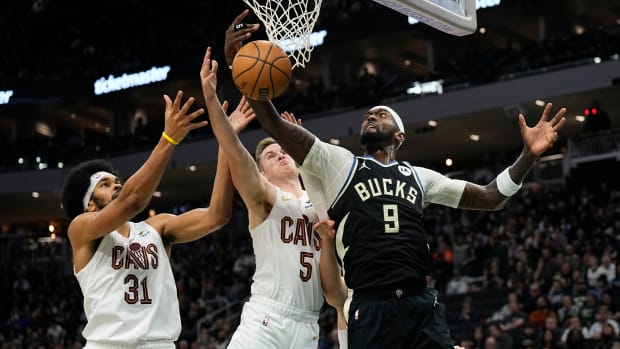 Jan 26, 2024; Milwaukee, Wisconsin, USA; Milwaukee Bucks forward Bobby Portis (9) reaches for a rebound in front of Cleveland Cavaliers center Jarrett Allen (31) and guard Malik Beasley (5) during the second quarter at Fiserv Forum. Mandatory Credit: Jeff Hanisch-USA TODAY Sports